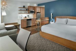 a hotel room with a bed and a kitchen at Element by Marriott Bainbridge Riverfront in Bainbridge