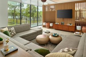 a living room with a couch and a flat screen tv at Element by Marriott Bainbridge Riverfront in Bainbridge