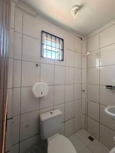 a white bathroom with a toilet and a sink at Hospedaria Maranhense in São Luís