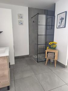 a bathroom with a shower and a table with flowers on it at Central Apartment 4P Playa Chica Beach 2min WIFI in Puerto del Carmen +34 photos