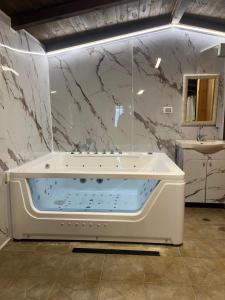 a bathroom with a bath tub and a sink at Good Time 99 in Shezor