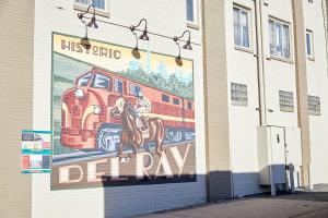 a mural of a train on the side of a building at Kasa Del Ray Alexandria in Alexandria