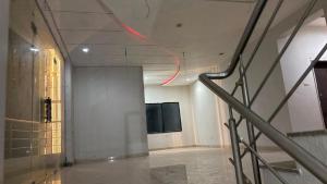 a hallway in a building with a red light on the ceiling at The Golden palace in Paratwāda