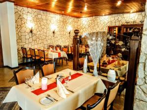 a dining room with tables and chairs in a restaurant at Landhotel Michaelishof in Bergen