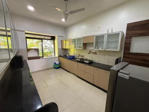 a large kitchen with a counter top at Sunleaf Palace in Pune