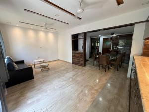 a living room with a couch and a table at Sunleaf Palace in Pune +3 photos