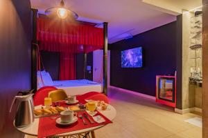 a room with a bed and a table with food on it at Dreams Motel (Adult Only) in Fortaleza