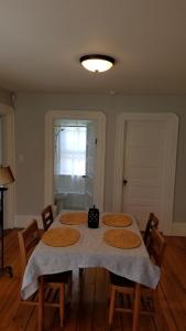 a dining room with a table with chairs and a window at Westport Point Farmhouse in Westport Point