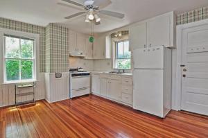 a kitchen with white appliances and a ceiling fan at Westport Point Farmhouse in Westport Point