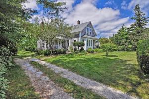 a house with a gravel road in front of it at Westport Point Farmhouse in Westport Point +10 photos