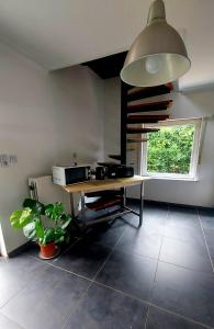 a living room with a table and a window at Maison Marthe in Sint-Truiden