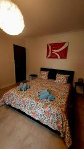 a bedroom with a bed with two stuffed animals on it at Maison Marthe in Sint-Truiden