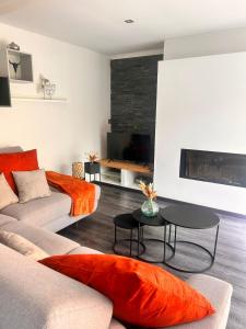 a living room with a couch and a fireplace at Maison Marthe in Sint-Truiden