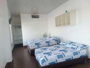 a bedroom with two beds in a room at Astilleros Santa Veronica in Santa Verónica