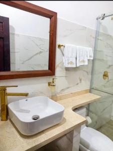 a white bathroom with a sink and a mirror at Hotel Boutique Porvenir Real in Charalá +18 photos