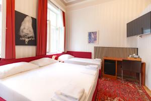 a room with two beds and a television at HPA Hotel Andreas in Vienna +39 photos