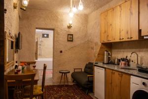 a kitchen with a sink and a table in a room at ÖzkanHouse in Ürgüp