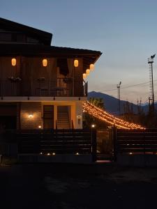 a house decorated with christmas lights at dusk at Castel Apartment in Castellamonte