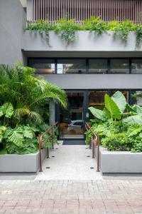 a building with plants in front of it at Neo House in Maringá