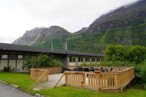 a building with a mountain in the background at Birtavarre Aurora Adventures in Birtavarre