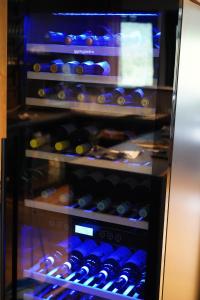 a refrigerator filled with lots of bottles of wine at Birtavarre Aurora Adventures in Birtavarre