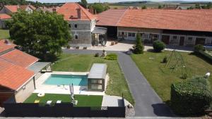 an aerial view of a house with a swimming pool at L'Hébergerie in Époye