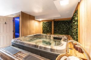 a jacuzzi tub in a room with plants at Mountain Forest Manor in Hiawassee