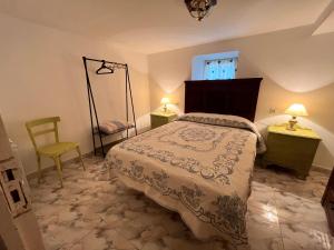 a bedroom with a bed and a chair and a window at A casa do teléfono in Pumares