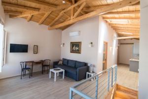 a living room with a blue couch and a table at Almond Suite in Hydra