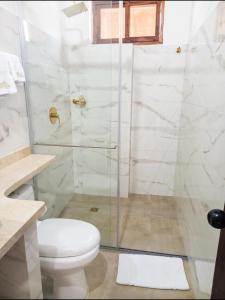 a bathroom with a shower and a toilet at Hotel Boutique Porvenir Real in Charalá