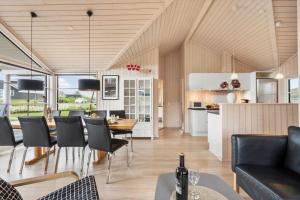 a kitchen and living room with a table and chairs at FY416-Frorup-Engparken-10 in Frørup