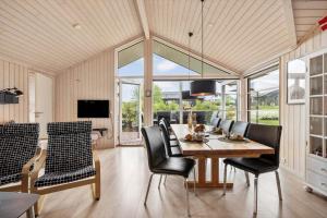 a dining room with a table and chairs at FY416-Frorup-Engparken-10 in Frørup
