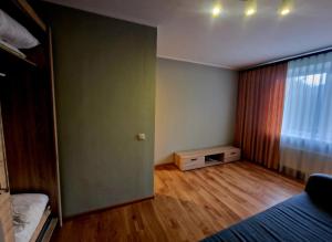an empty room with a bed and a window at Omes puurs in Ventspils