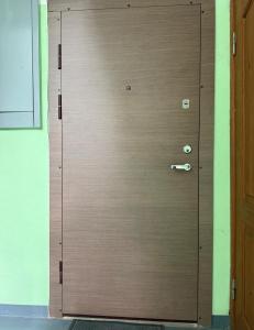 a large wooden door with a handle in a room at Omes puurs in Ventspils