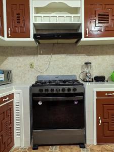 a kitchen with a black stove top oven at Casa Cariño in San Cristóbal de Las Casas +37 photos