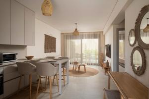 a kitchen and living room with a table and chairs at DARION Residence in Nikiti