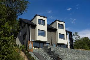 a house on top of a stone wall at SAUERLAND CHALETS - "Die Chalets Lieblingsplatz" in Winterberg