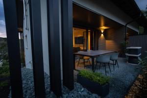 a house with a table and chairs on a patio at SAUERLAND CHALETS - "Die Chalets Lieblingsplatz" in Winterberg