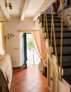 a room with a staircase with a bed and a window at Casita de Mar in Tossa de Mar