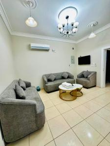 a living room with two couches and a table at شقق ارين المصيف للشقق المخدومة in Al Hada
