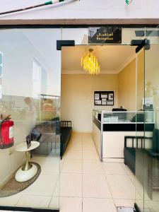 a window of a store with a table in it at شقق ارين المصيف للشقق المخدومة in Al Hada