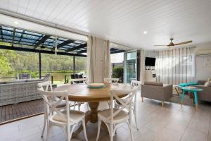 a dining room with a table and chairs at The River House - Wisemans Ferry in Wisemans Ferry