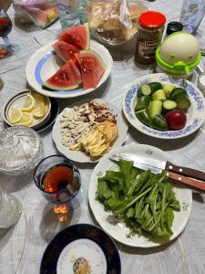 a table with plates of food on it at Old House in Sheki