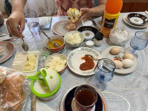 a table topped with plates and bowls of food at Old House in Sheki