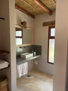 a bathroom with a sink and a mirror at Aguacanto Cabañas in Tilcara +36 photos