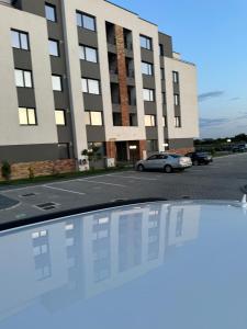 a car parked in a parking lot in front of a building at Day Studio in Focşani +19 photos