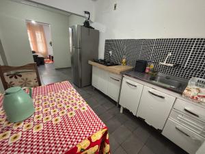 a kitchen with a table and a refrigerator at Apto João-de-Barro in Rondonópolis