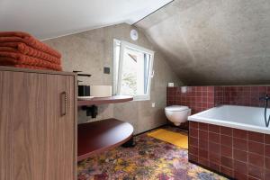 a bathroom with a tub and a toilet and a sink at L'Entre Nous Climatisation Terrasse in Saint Avre la Chambre +53 photos