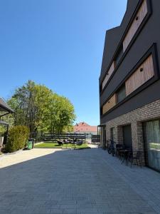 a building with chairs and tables outside of it at Silence in Zator
