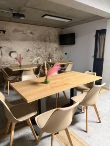 a dining room with tables and chairs and a mural at Silence in Zator
